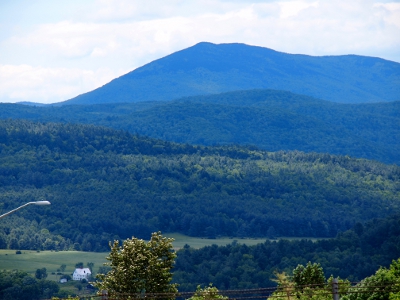 [Several layers of completely tree covered mountains. Each layer further in the distance has more haze.]